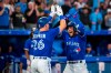 Toronto Blue Jays' George Springer (4) celebrates with Matt Chapman (26) after hitting a grand slam during sixth inning interleague Major League Baseball action against the St. Louis Cardinals, in Toronto on Tuesday, July 26, 2022. THE CANADIAN PRESS/Christopher Katsarov