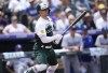 Colorado Rockies' Randal Grichuk folows the flight of his single that drove in two runs off Los Angeles Dodgers starting pitcher Tony Gonsolin in the third inning of a baseball game Sunday, July 31, 2022, in Denver. (AP Photo/David Zalubowski)