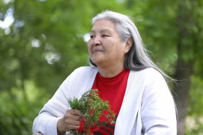 Chickadee Richard holds a bouquet of cedar, one of the medicines she gathers and uses. (Ruth Bonneville / Winnipeg Free Press)