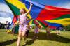 DANIEL CRUMP / WINNIPEG FREE PRESS
Alice Mierau, 6, plays under a parachute during the Winnipeg Folk Festival Saturday.