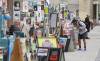 MIKE DEAL / WINNIPEG FREE PRESS
Ray Strachan checks out the fringe posters plastered along Market Avenue.