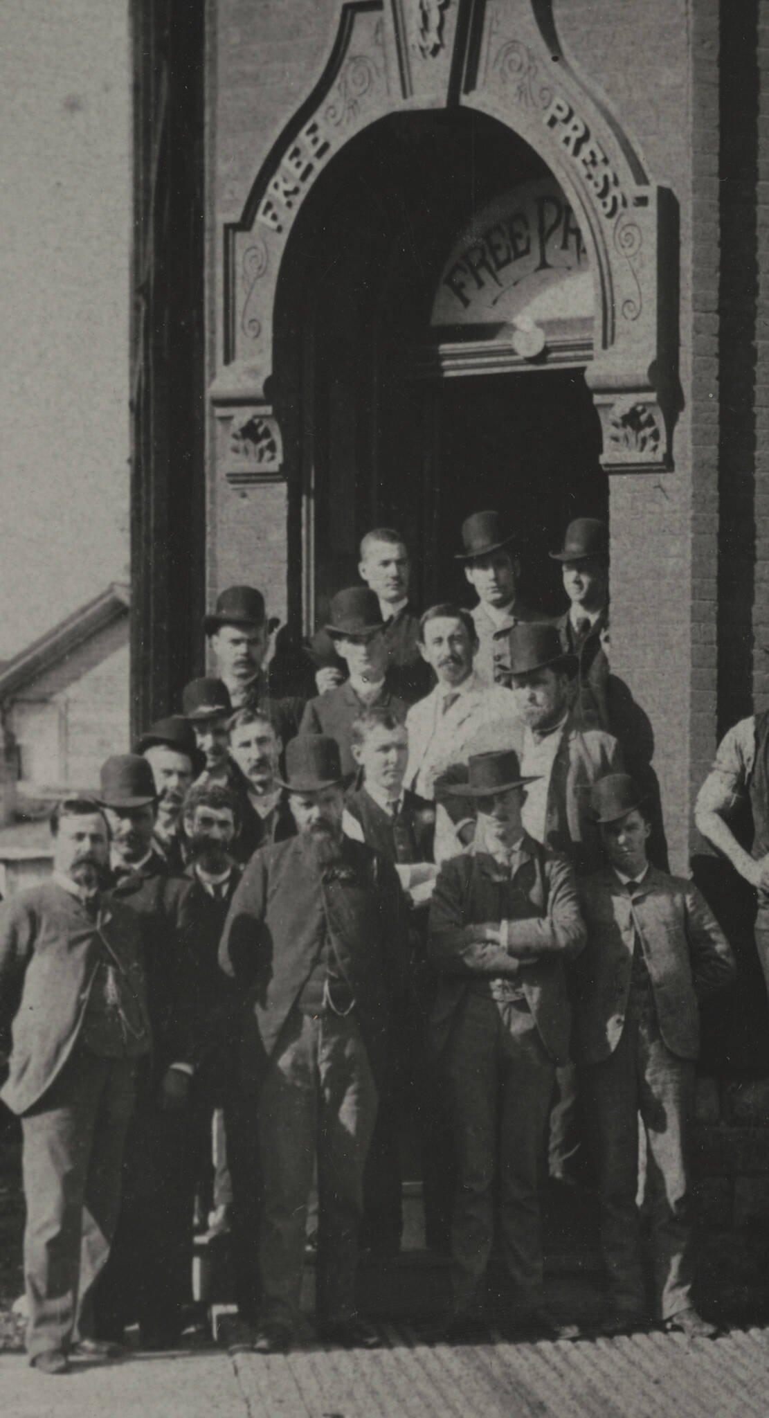 Image of W.F. Luxton, Free Press editor and publisher, the newspaper’s city editor John W. Dafoe and others standing in front of the Free Press offices in 1886.