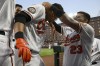 Baltimore Orioles' Ryan Mountcastle, left, gets the home run chain from Robinson Chirinos, right, as he celebrates after his home run during the third inning of a baseball game against the Toronto Blue Jays, Monday, Aug. 8, 2022, in Baltimore. (AP Photo/Nick Wass)