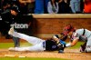 Philadelphia Phillies catcher J.T. Realmuto, right, tags out New York Mets' Starling Marte at home plate to end the ninth inning of a baseball game Friday, Aug. 12, 2022, in New York. (AP Photo/Frank Franklin II)