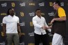 San Diego Padres outfielder Juan Soto, center, shakes hands with manager Bob Melvin as first baseman Josh Bell looks on during a news conference at Petco Park Wednesday, Aug. 3, 2022, in San Diego. Soto, the generational superstar whose trade-deadline acquisition instantly made the Padres a strong playoff contender, was introduced at a news conference Wednesday along with fellow newcomer Josh Bell. (AP Photo/Gregory Bull)
