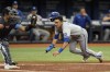 Kansas City Royals' Nicky Lopez begins to slide past Tampa Bay Rays catcher Christian Bethancourt while scoring on a sacrifice fly by Bobby Witt Jr. during the fifth inning of a baseball game Sunday, Aug. 21, 2022, in St. Petersburg, Fla. (AP Photo/Chris O'Meara)