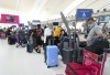 Lawmakers and advocates in the United States are ramping up the pressure on the federal government to ease travel delays between the U.S. and Canada. People wait in line to check in at Pearson International Airport in Toronto on Thursday, May 12, 2022. THE CANADIAN PRESS/Nathan Denette