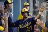Milwaukee Brewers' Willy Adames (27) celebrates in the dugout after scoring off of a double hit by Hunter Renfroe during the third inning of a baseball game against the Los Angeles Dodgers in Los Angeles, Wednesday, Aug. 24, 2022. (AP Photo/Ashley Landis)