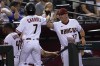 Arizona Diamondbacks' manager Torey Lovullo high fives Arizona Diamondbacks' Corbin Carroll (7) during the fourth inning of a baseball game, Monday, Aug. 29, 2022, in Phoenix. (AP Photo/Matt York)