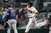 Atlanta Braves' Austin Riley (27) runs past Colorado Rockies first baseman C.J. Cron (25) after hitting a home run during the fourth inning of a baseball game Thursday, Sept. 1, 2022, in Atlanta. (AP Photo/John Bazemore)