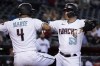 Arizona Diamondbacks' Christian Walker (53) celebrates with Ketel Marte (4) after hitting a two-run home run against the Milwaukee Brewers during the first inning of a baseball game Thursday, Sept. 1, 2022, in Phoenix. (AP Photo/Matt York)