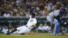 Detroit Tigers' Ryan Kreidler scores as Kansas City Royals catcher Salvador Perez waits for the throw in the fifth inning of a baseball game in Detroit, Friday, Sept. 2, 2022. (AP Photo/Paul Sancya)