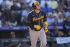 Milwaukee Brewers' Victor Caratini circles the bases after hitting a three-run home run off Colorado Rockies relief pitcher Justin Lawrence in the sixth inning of a baseball game Monday, Sept. 5, 2022, in Denver. (AP Photo/David Zalubowski)