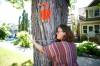 MIKE DEAL / WINNIPEG FREE PRESS
Ariel Gordon hugging her 110-year-old elm tree.