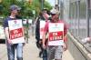 Manitoba Hydro workers strike outside the Manitoba Hydro building in June. (File)