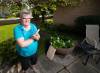 ETHAN CAIRNS / WINNIPEG FREE PRESS
                                Connie Newman, executive director of the Manitoba Association of senior communities stands with landline handset outside of her home in Winnipeg Friday, August 26, 2022. She is encouraging people to talk about scams and be open about them as most stay quiet due to embarrassment.