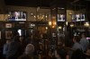 People watch a broadcast of Britain's King Charles III first address to the nation as the new King following the death of Queen Elizabeth II, in London, Friday, Sept. 9, 2022. Queen Elizabeth II, Britain's longest-reigning monarch and a rock of stability across much of a turbulent century, died Thursday Sept. 8, 2022, after 70 years on the throne. She was 96. (AP Photo/Felipe Dana)