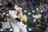 Milwaukee Brewers' Willy Adames hits a two-run home run during the first inning of a baseball game against the Cincinnati Reds, Saturday, Sept. 10, 2022, in Milwaukee. (AP Photo/Aaron Gash)