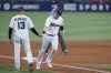 Miami Marlins major league third base coach Al Pedrique (13) congratulates Brian Anderson after Anderson hit a home run during the fourth inning of a baseball game against the New York Mets, Sunday, Sept. 11, 2022, in Miami. (AP Photo/Wilfredo Lee)