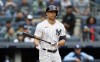 New York Yankees' Giancarlo Stanton tosses his bat after a walk during the first inning a baseball game against the Tampa Bay Rays on Sunday, Sept. 11, 2022, in New York. (AP Photo/Noah K. Murray)