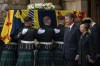 From second right, Vice Admiral Timothy Laurence and Princess Anne stand as the coffin of Queen Elizabeth II, draped with the Royal Standard of Scotland, completes its journey from Balmoral to the Palace of Holyroodhouse, where it will lie in rest for a day, in Edinburgh, Sunday, Sept. 11, 2022. Queen Elizabeth II, Britain's longest-reigning monarch and a rock of stability across much of a turbulent century, died Thursday Sept. 8, 2022, after 70 years on the throne. She was 96. (Aaron Chown/Pool Photo via AP)