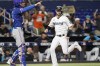 Miami Marlins' Charles Leblanc, right, scores past Texas Rangers catcher Jonah Heim, left, on a single hit by Jon Berti in the fifth inning during Game 2 of a doubleheader baseball game, Monday, Sept. 12, 2022, in Miami. (AP Photo/Lynne Sladky)