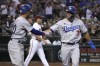 Los Angeles Dodgers' Chris Taylor (3) celebrates with Mookie Betts after scoring a run on a ball hit by Cody Bellinger (35) in the seventh inning during a baseball game against the Arizona Diamondbacks, Monday, Sept. 12, 2022, in Phoenix. (AP Photo/Rick Scuteri)
