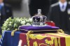 A view of the coffin of Queen Elizabeth II, adorned with a Royal Standard and the Imperial State Crown and pulled by a Gun Carriage of The King's Troop Royal Horse Artillery, during a procession from Buckingham Palace to Westminster Hall in London, Wednesday, Sept. 14, 2022. THE CANADIAN PRESS/AP-Daniel Leal/Pool Photo via AP