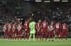 Liverpool's players stand for a minute of silence for the death of Britain's Queen Elizabeth II prior to the start of the Champions League group A soccer match between Liverpool and Ajax at Anfield stadium in Liverpool, England, Tuesday, Sept. 13, 2022. (AP Photo/Rui Vieira)