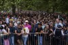 FILE - People wait in line to lay flowers for Queen Elizabeth II in front of Buckingham Palace, in London, Sept. 11, 2022. Because she reigned and lived for so long, Queen Elizabeth II's death was a reminder that mortality and the march of time are inexorable. (AP Photo/Nariman El-Mofty, File)