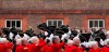 FILE - Chelsea Pensioners raise their hats as they offer three cheers for Britain's Queen Elizabeth II, as they take part in their Founders Day parade in London, Thursday, June 7, 2012. The Royal Hospital Chelsea has been caring for Britain's veteran soldiers since its foundation by King Charles II in 1682, the veterans known as Chelsea Pensioners are easily identifiable by their traditional red coats. (AP Photo/Alastair Grant, File)