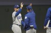 Los Angeles Dodgers' Trayce Thompson, left, celebrates with manager Dave Roberts after the Dodgers defeated the San Francisco Giants in a baseball game in San Francisco, Saturday, Sept. 17, 2022. (AP Photo/Jeff Chiu)