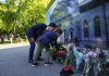 Prime Minister Justin Trudeau and son Hadrien place flowers for Queen Elizabeth II as they arrive to a ceremony to proclaim the accession of the new Sovereign, King Charles III at Rideau Hall in Ottawa, Saturday, Sept. 10, 2022. THE CANADIAN PRESS/Sean Kilpatrick