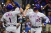 New York Mets' Pete Alonso is congratulated by Jeff McNeil after hitting a three-run home run during the fourth inning of a baseball game against the Milwaukee Brewers Monday, Sept. 19, 2022, in Milwaukee. (AP Photo/Morry Gash)