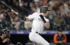 Colorado Rockies' Michael Toglia, right, follows the flight of his RBI-triple off San Francisco Giants starting pitcher Jakob Junis in the second inning of a baseball game Monday, Sept. 19, 2022, in Denver. (AP Photo/David Zalubowski)