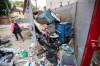 Angela Klassen Janeczko walks by a newly installed and overflowing garbage container behind an apartment building during a Bear Clan patrol in Winnipeg's West Broadway neighbourhood on Sunday, Sept. 18, 2022. THE CANADIAN PRESS/Daniel Crump