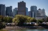 Tents are seen at a homeless encampment at Crab Park as the downtown skyline rises behind them in Vancouver, on Sunday, August 14, 2022. Housing anxiety in British Columbia encompasses young professionals who can't raise enough cash for down payments, students and low-income families unable to afford rent and people in tents fearful they will die homeless, says Canada's federal housing advocate. THE CANADIAN PRESS/Darryl Dyck