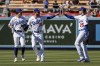 Los Angeles Dodgers' Cody Bellinger (35) celebrates with Trayce Thompson (25) and Miguel Vargas after the Dodgers defeated the Arizona Diamondbacks in a baseball game Tuesday, Sept 20, 2022, in Los Angeles. (AP Photo/Ringo H.W. Chiu)