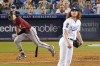 Arizona Diamondbacks' Corbin Carroll, left, runs to first after hitting a three RBI double as Los Angeles Dodgers starting pitcher Dustin May watches during the fourth inning of a baseball game Wednesday, Sept. 21, 2022, in Los Angeles. (AP Photo/Mark J. Terrill)