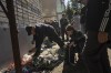 People charge their phones and electronic devices powered by a generator in the recently retaken area of Izium, Ukraine, Wednesday, Sept. 21, 2022. (AP Photo/Evgeniy Maloletka)