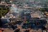 FILE - Ukrainian State Emergency Service firefighters work to take away debris at a shopping center burned after a rocket attack in Kremenchuk, Ukraine, June 28, 2022. Residents of Moscow-controlled regions in Ukraine are set to start voting Friday Sept. 23, 2022, on whether to join Russia in Kremlin-engineered referendums that set the stage for a sharp escalation of the nearly seven-month war. (AP Photo/Efrem Lukatsky, File)