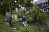 People work to drag a fallen tree limb from their street as post tropical storm Fiona causes widespread damage in Halifax on Saturday, September 24, 2022. THE CANADIAN PRESS/Darren Calabrese