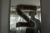 A Ukrainian serviceman inspects a kindergarten classroom with a sign 