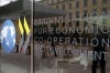 FILE - The logo at the entrance of the Organisation for Economic Co-operation and Development (OECD) headquarters in Paris, June 7, 2017. The OECD on Monday, Sept. 26, 2022 says Russia’s war in Ukraine and the lingering effects of the COVID-19 pandemic are dragging down global economic growth more than expected and driving up inflation that will stay high into next year. The Paris-based organization projects worldwide growth to be a modest 3% this year before slowing further to just 2.2% next year, representing around $2.8 trillion in lost global output in 2023. (AP Photo/Francois Mori, file)