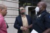 Former D.C. Metropolitan Police Officer Michael Fanone, center, shakes hands with a Capitol Police officer as Capitol Police Sgt. Aquilino Gonell, left, stands by outside the federal courthouse, after Kyle Young, who assaulted Fanone during the Jan. 6 riots, was sentenced to more than seven years in prison after a trial in Washington, Tuesday, Sept. 27, 2022. ( AP Photo/Jose Luis Magana)