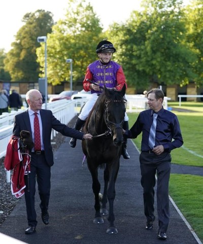 Educator and Tom Marquand after the Radcliffe & Co Handicap at Salisbury Racecourse, Thursday Sept. 29, 2022. The famous royal silks returned to British horse racing on Thursday, with the first runner under the ownership of King Charles III, Educator, finishing a distant second at Salisbury. (Andrew Matthews/PA via AP)