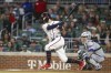 Atlanta Braves' Dansby Swanson follows through on a single during the third inning of the team's baseball game against the New York Mets, Saturday, Oct. 1, 2022, in Atlanta. (AP Photo/Brett Davis)
