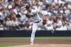 San Diego Padres third baseman Brandon Dixon attempts to throw out San Francisco Giants' Austin Slater at first base in the second inning of a baseball game, Wednesday, Oct. 5, 2022, in San Diego. Slater was safe at first on the play. (AP Photo/Derrick Tuskan)