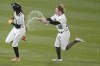 Pittsburgh Pirates' Jack Suwinski (65) squirts water bottles at Oneil Cruz after Cruz was walked with the bases loaded during the ninth inning, letting in the winning run, of a baseball game against the St. Louis Cardinals, Monday, Oct. 3, 2022, in Pittsburgh. (AP Photo/Keith Srakocic)
