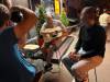 MELISSA MARTIN / WINNIPEG FREE PRESS
                                Sasha, in the middle, blows smoke as he plays guitar outside a central Kyiv hostel, next to another young man displaced from Kharkiv.